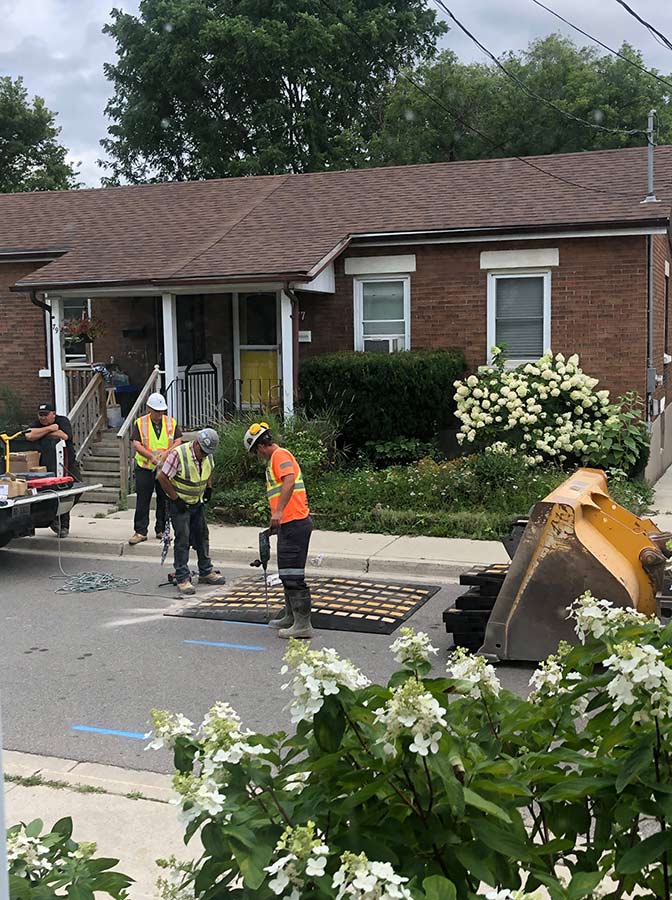 City workers install temporary speed bumps on Alice Street